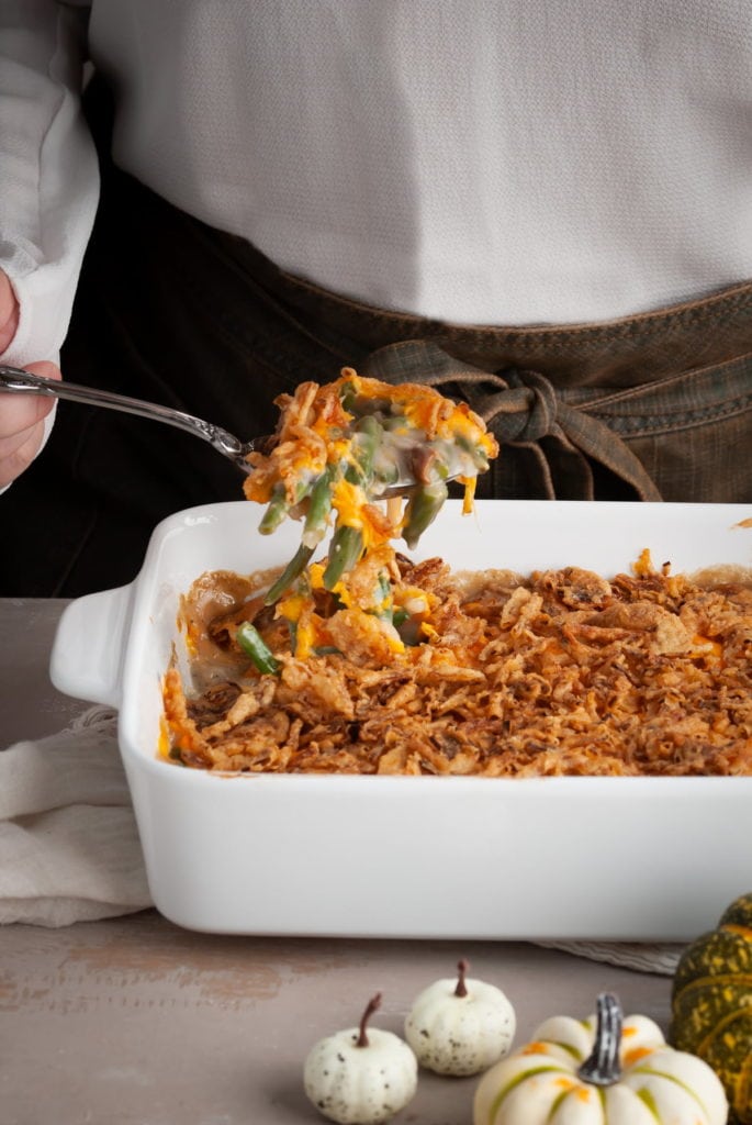 Green Bean Casserole with Secret Ingredient being lifted on a serving spoon