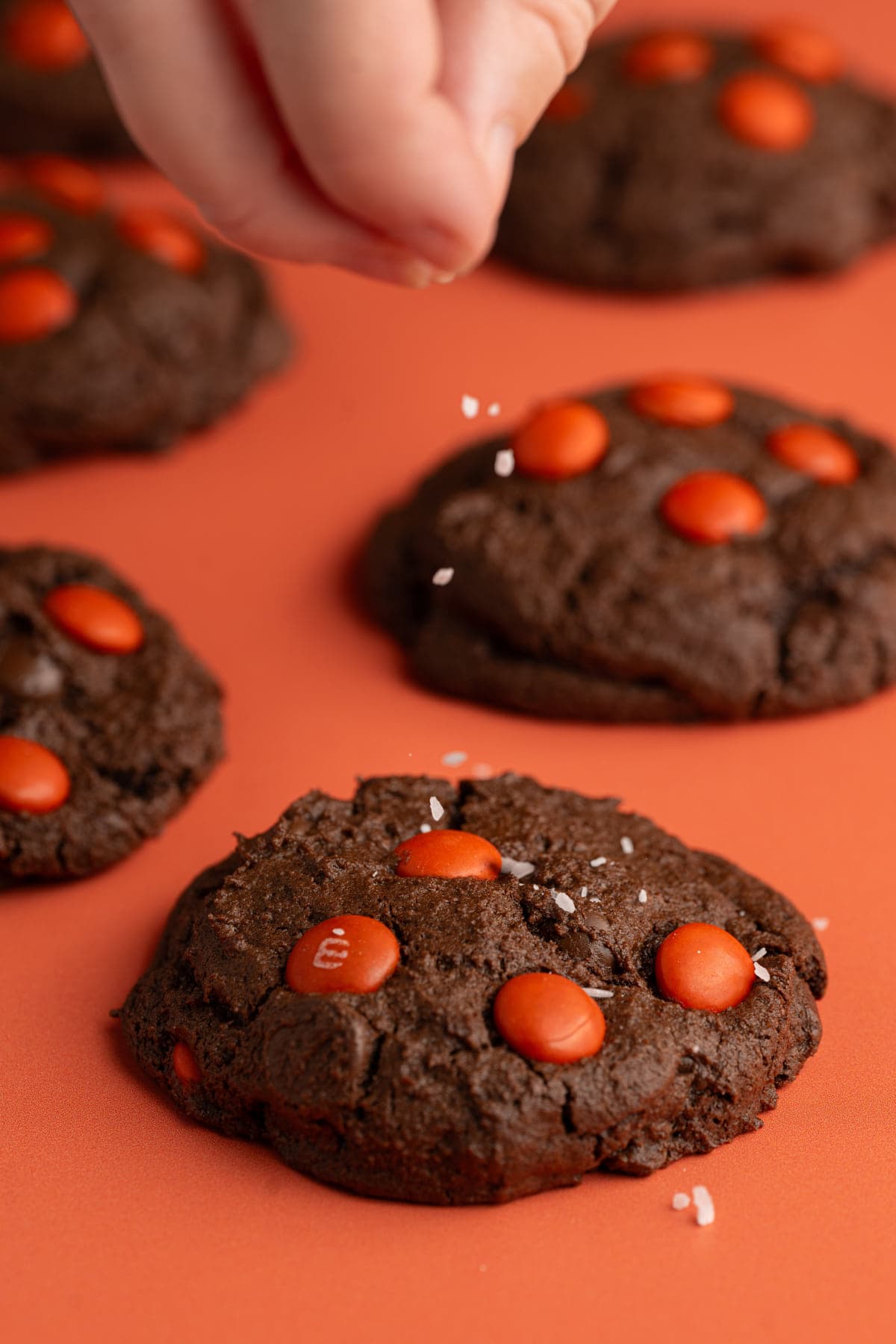 Adding flaky sea salt to double chocolate cookies with M&M's