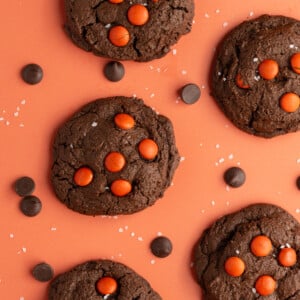 Double Chocolate Halloween M&M Cookies on orange background