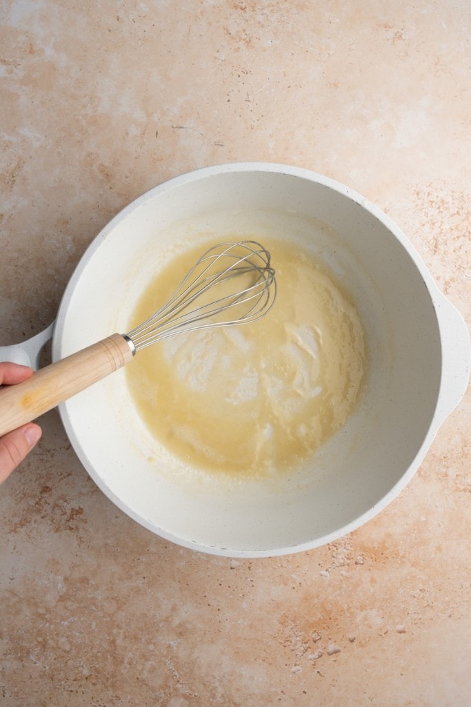 Forming a roux with olive oil and flour to make thick enchilada sauce