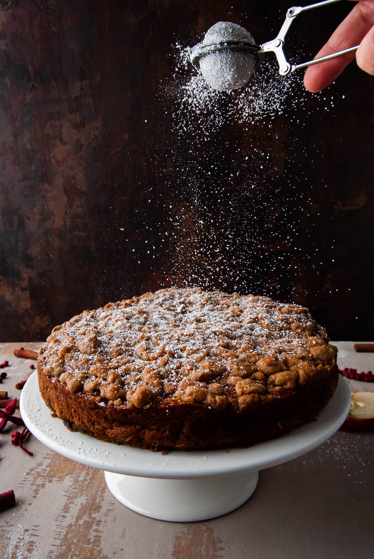 dusting vegan apple cake with powdered sugar