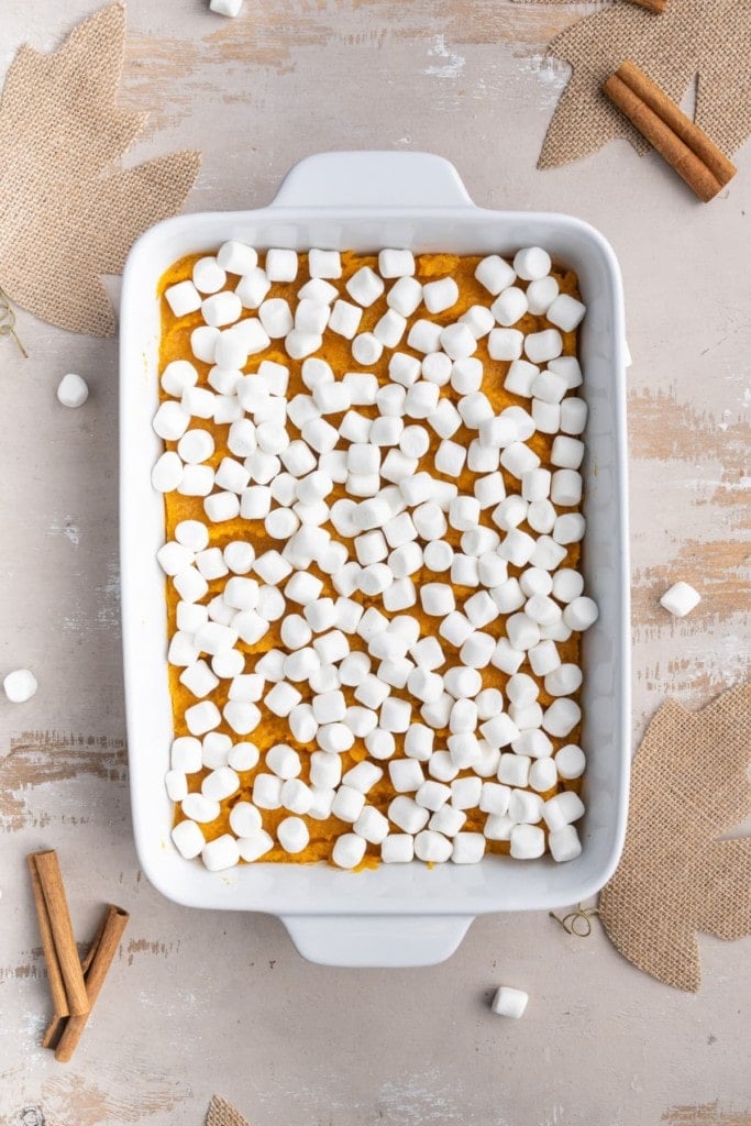 adding layer of marshmallows to maple sweet potato casserole