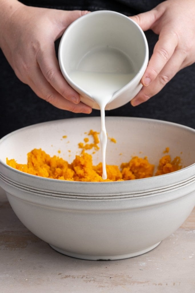 adding milk to sweet potato