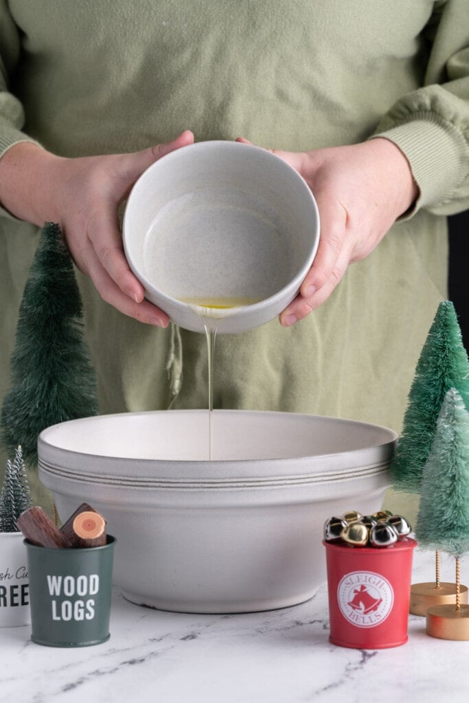 Adding egg whites to a mixing bowl to make royal icing