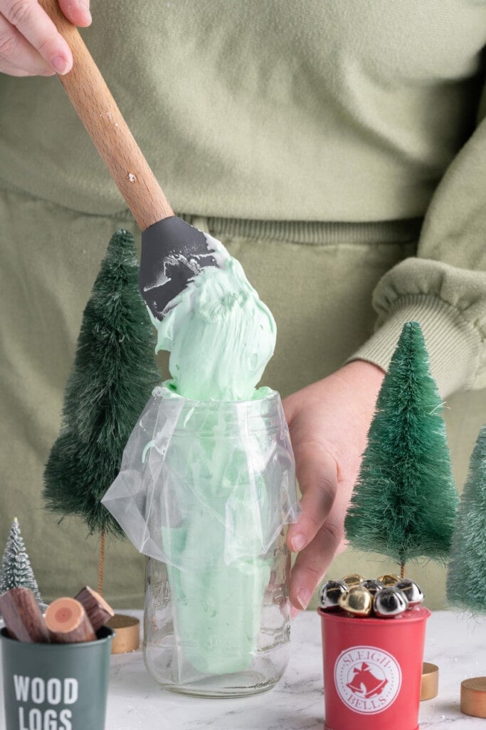 Adding green royal icing to a piping bag