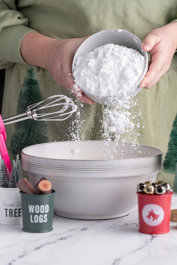 Adding powdered sugar to whipped egg whites to make icing