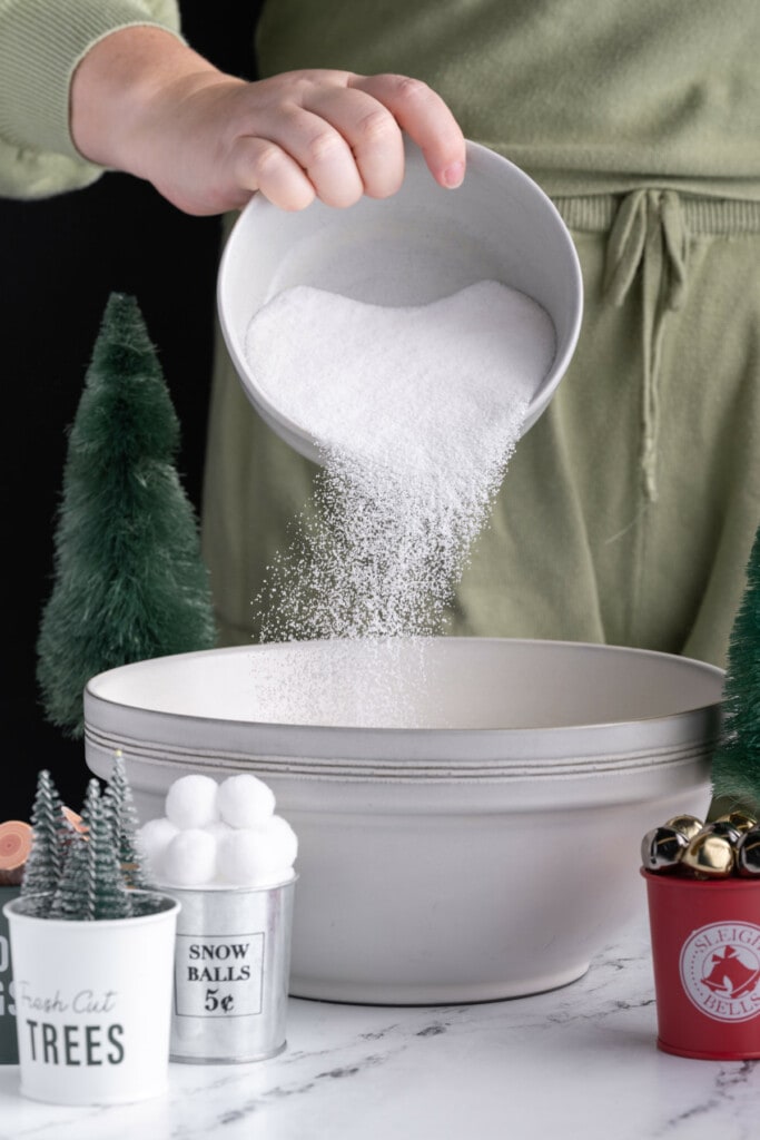 Pouring sugar into a mixing bowl in Chrsitmas scene