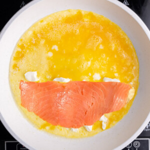 Lox on top of cream cheese in an egg omelet.