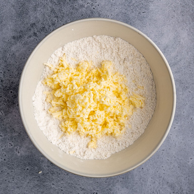 Adding grated butter to dry crust ingredients