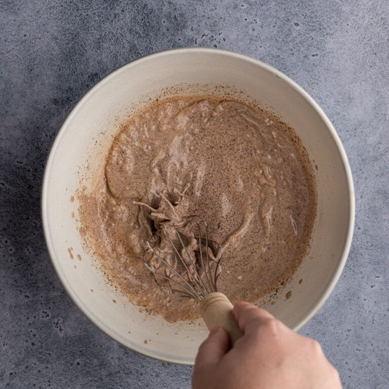 Whisking chocolate chips into cream to melt them