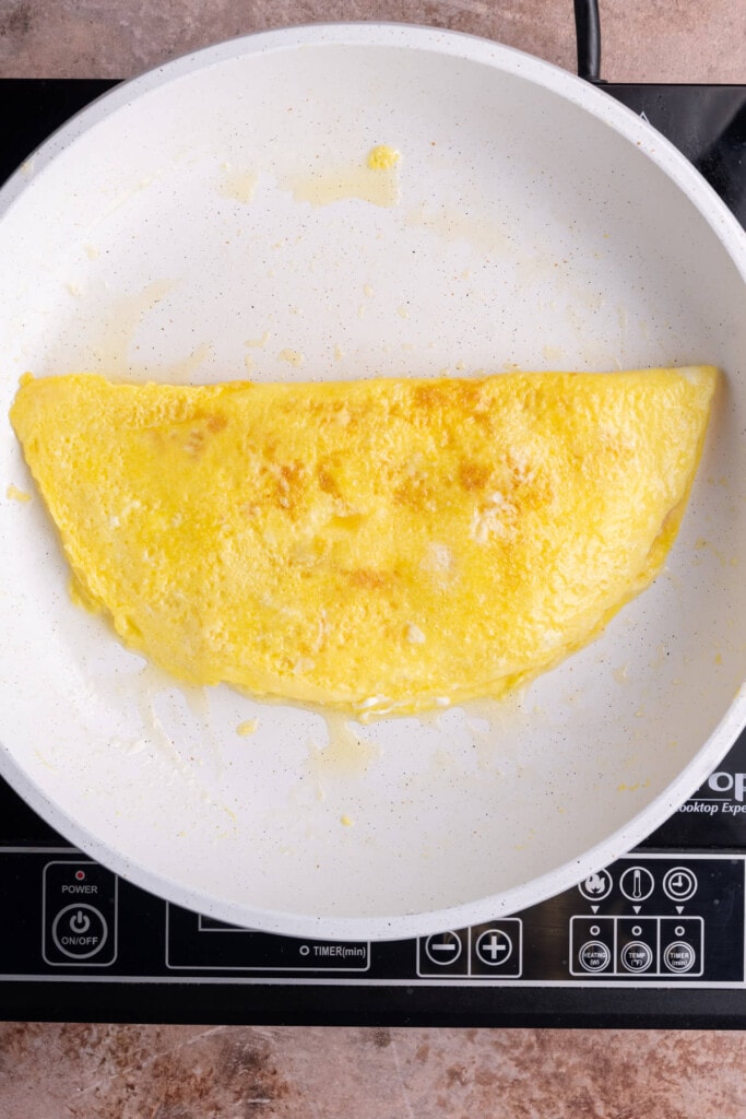 Omelet just flipped in pan.