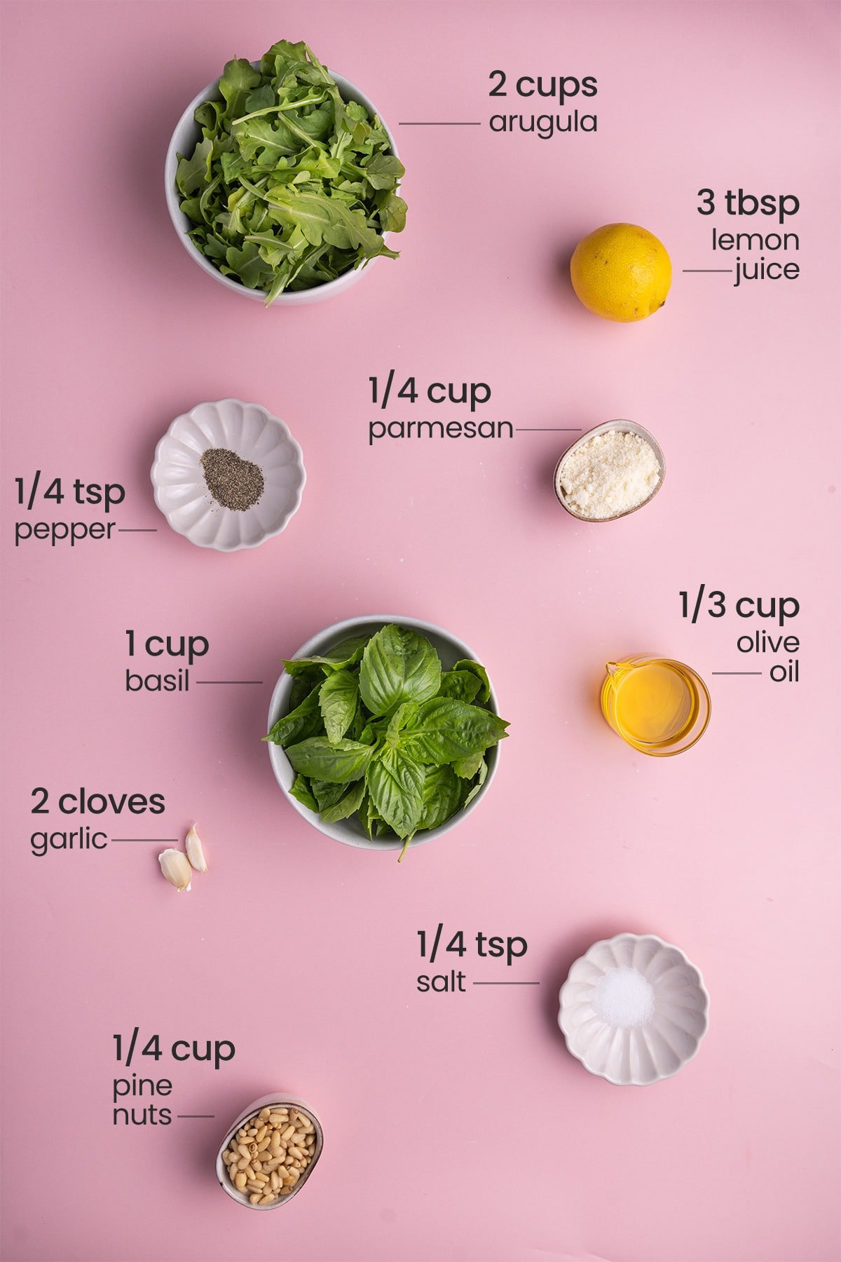 pesto ingredients - arugula, lemon, pepper, parmesan, basil, oil, salt, garlic, pine nuts