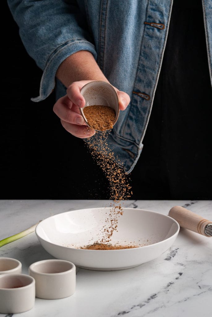 adding old bay to shallow bowl to make blackening seasoning