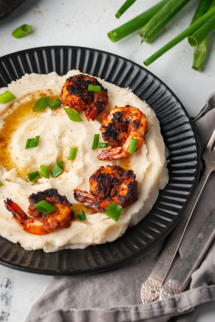 plated old bay mashed potatoes with blackened shrimp on top