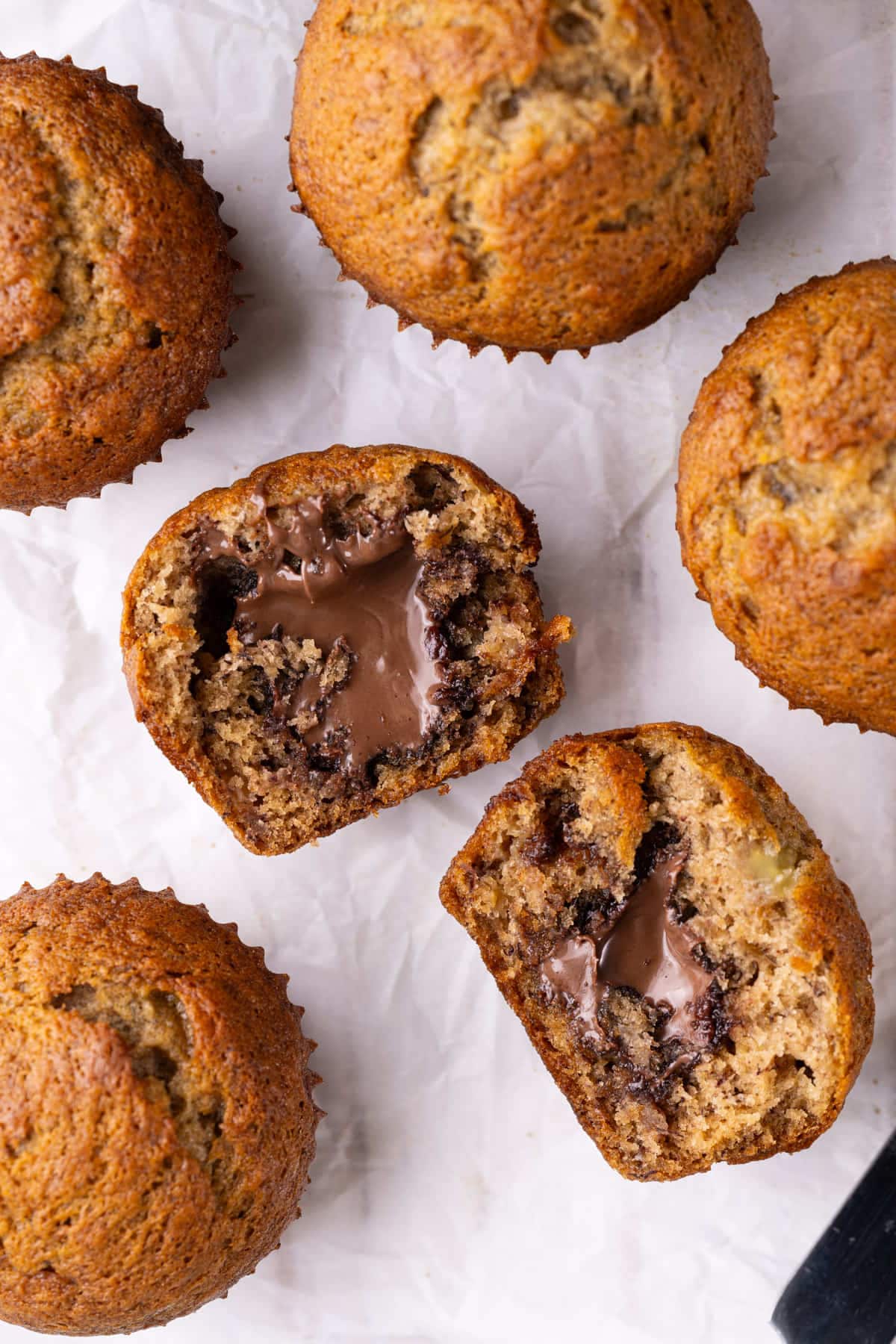 Close up of banana muffins sliced open to reveal nutella in the center.