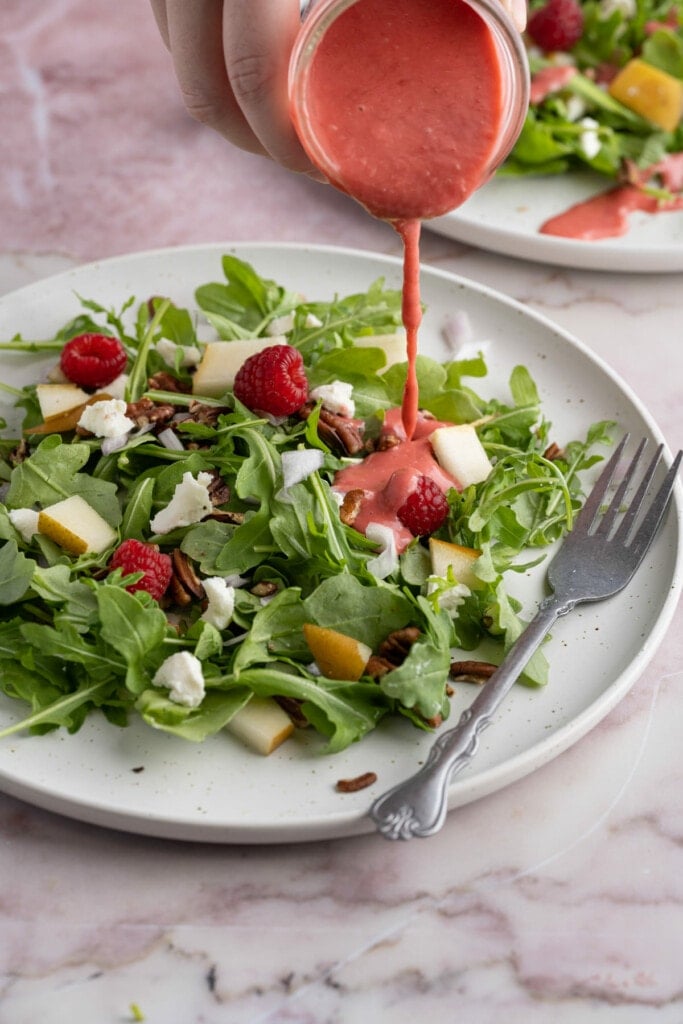 Serving raspberry vinaigrette over a salad