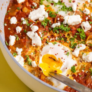 Cutting into yolk on Spicy Feta Shakshuka