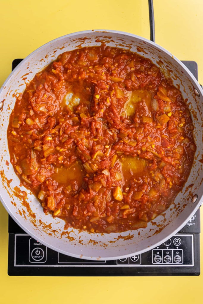 Carving wells out in shakshuka to fry eggs