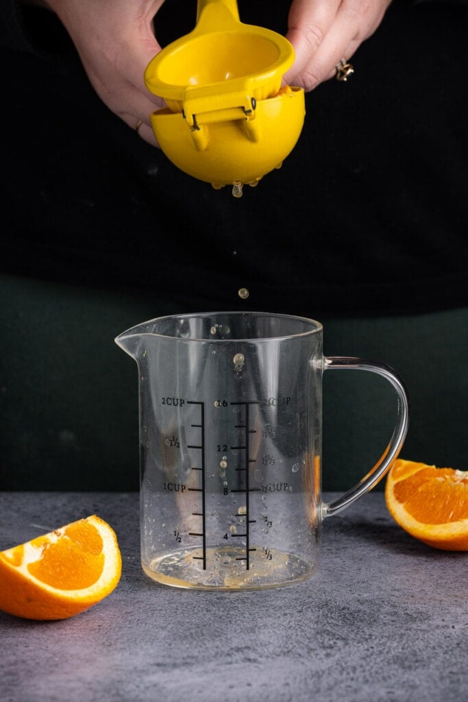 Juicing orange to make sticky orange sauce for tofu