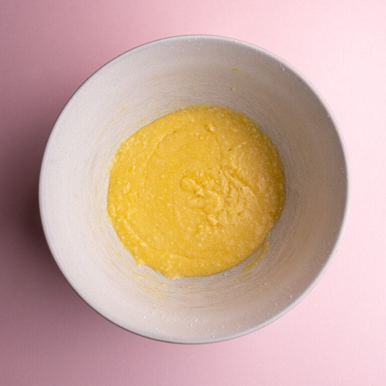 Butter, sugar, eggs, and vanilla extract beat together in a large mixing bowl.
