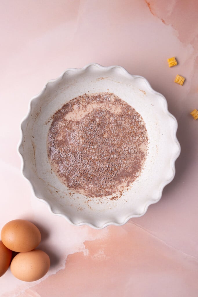Milk, vanilla extract, and cinnamon mixed together to make a more evenly seasoned egg wash.