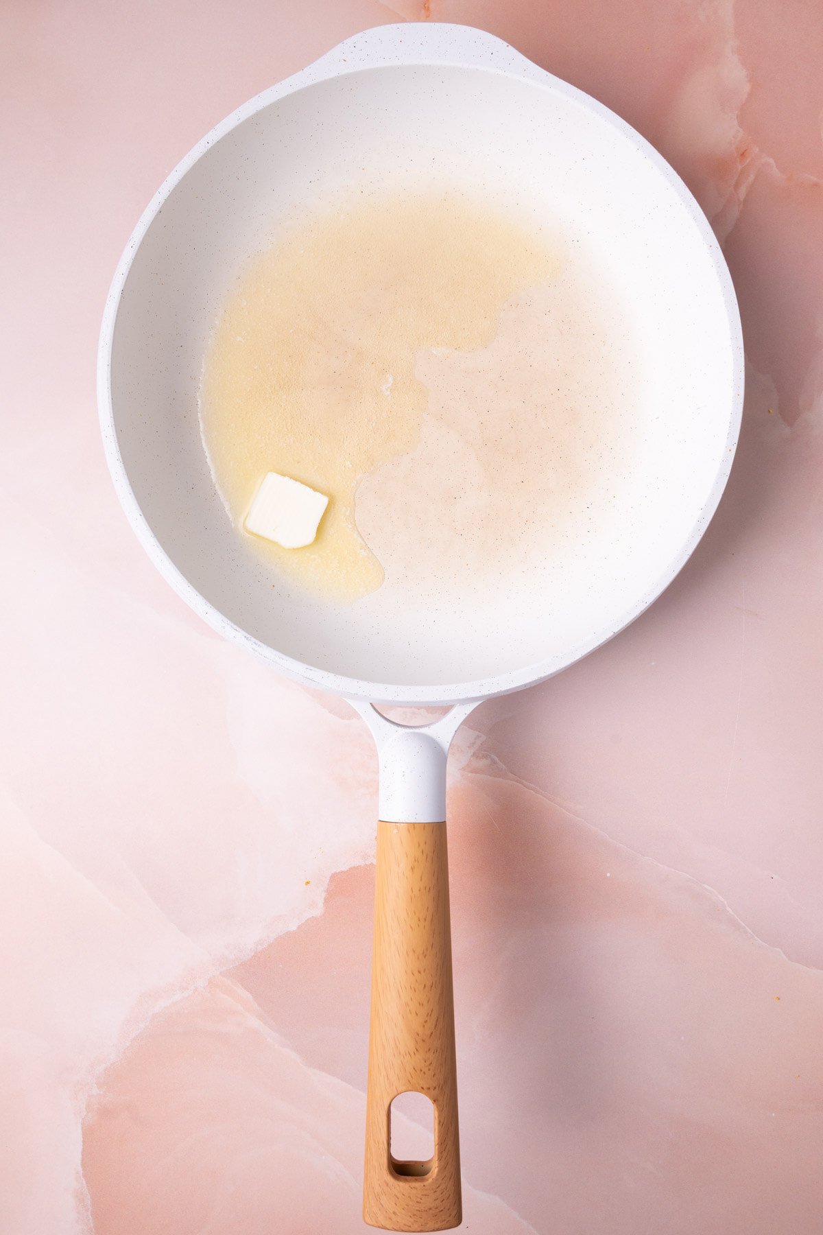 Butter melting in a pan to get hot before adding French toast to fry in it. 