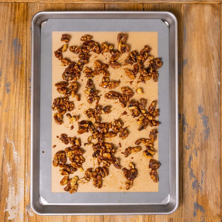 Large baking sheet with cinnamon sugar coated walnuts