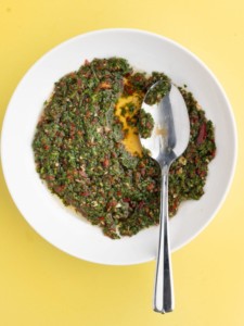 serrano pepper chimichurri in a shallow bowl with a serving spoon