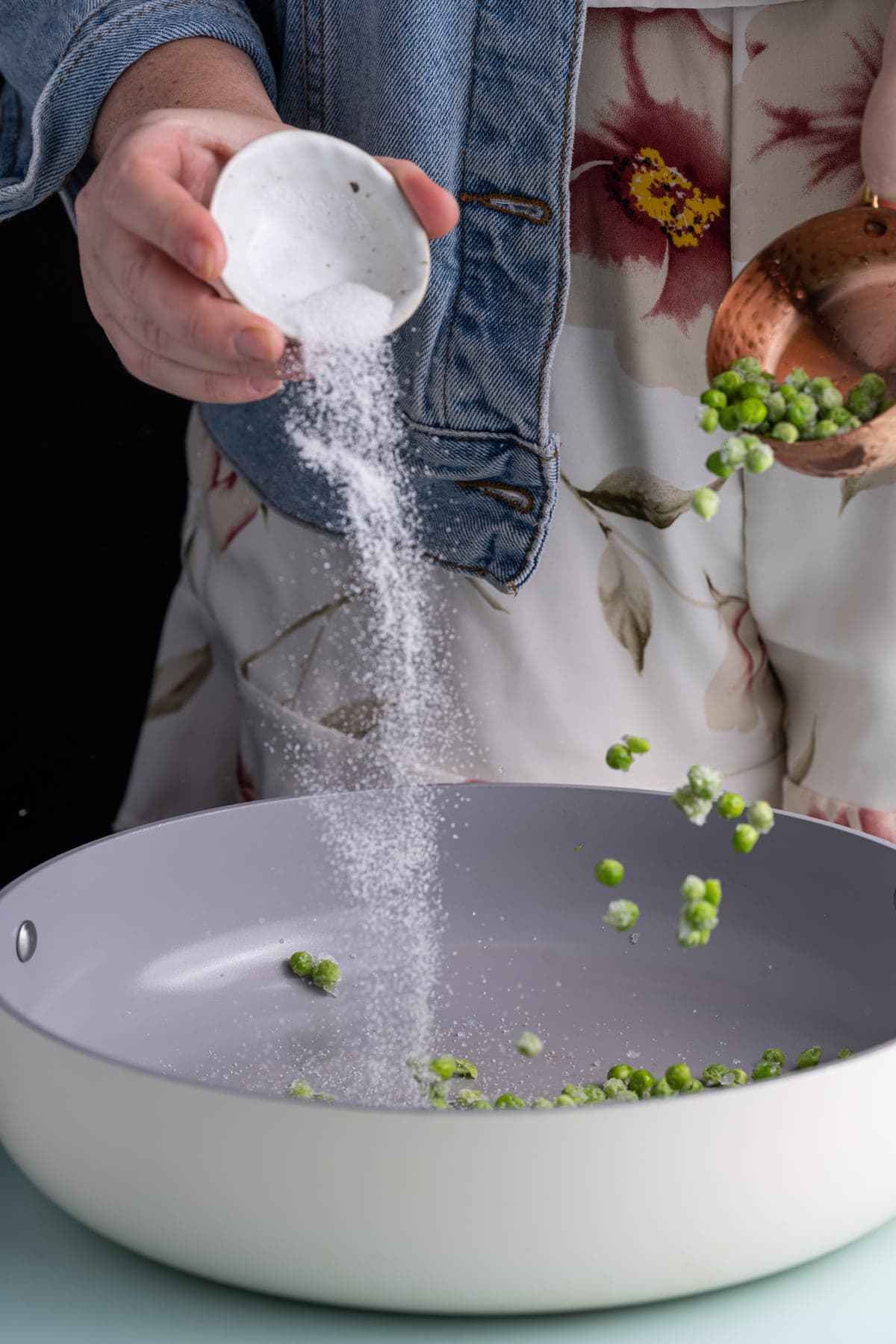 Cooking green peas in butter and sugar to bring out their natural sweetness