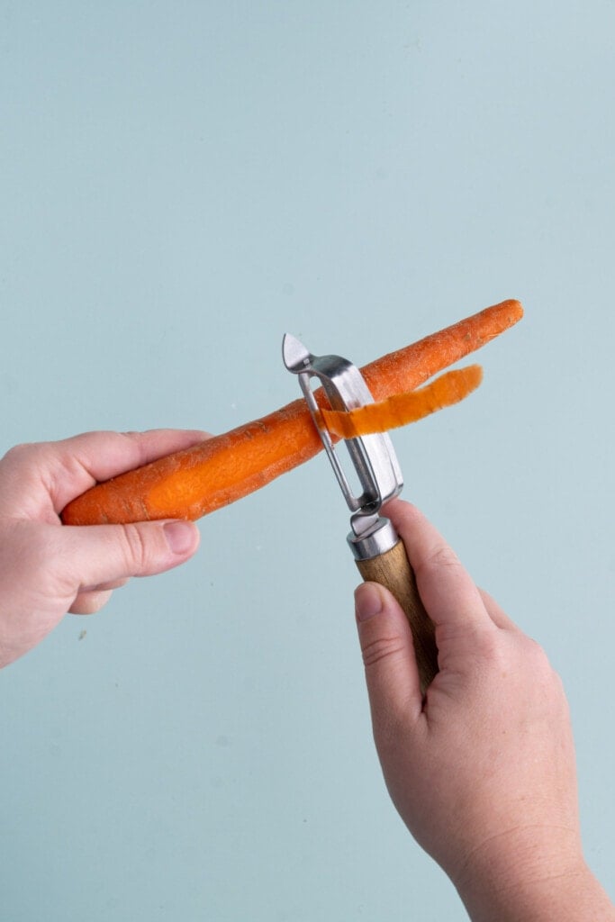 Peeling away the bitter outer layer of a carrot