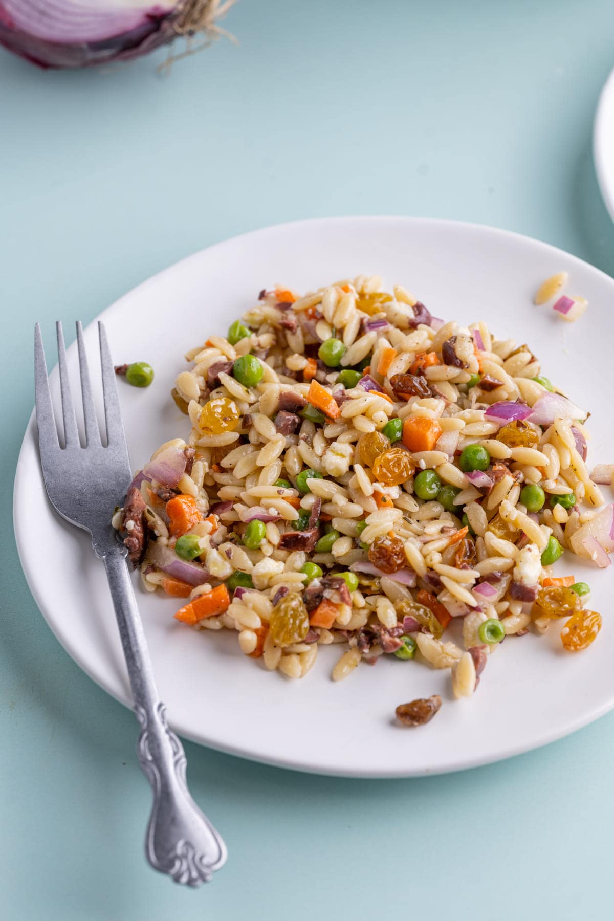 Rainbow Orzo Salad on a white plate with a fork