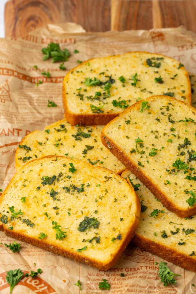 Close up of freshly baked Texas Toast garlic bread on a wooden board. 