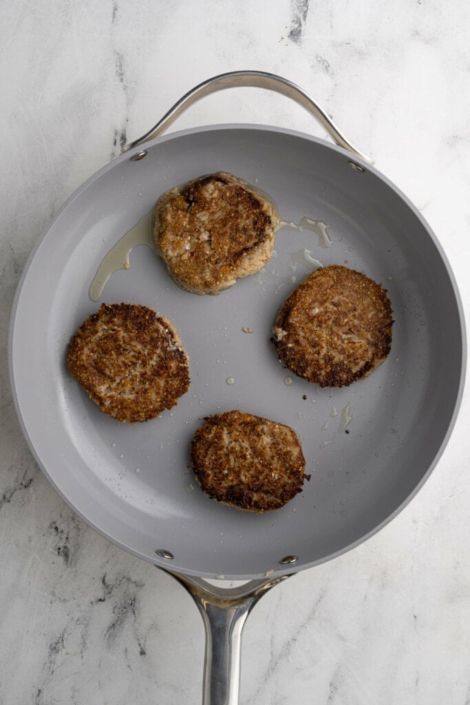 Frying apple and sage sausage in olive oil