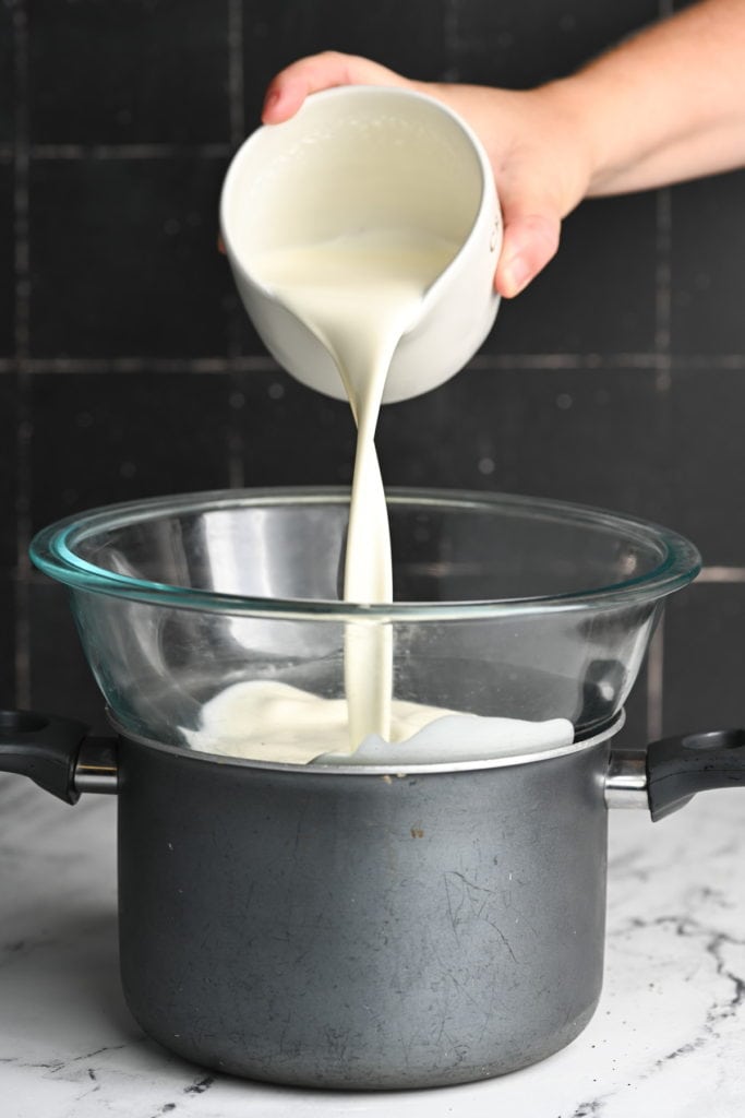 adding heavy cream to a double boiler to safely heat
