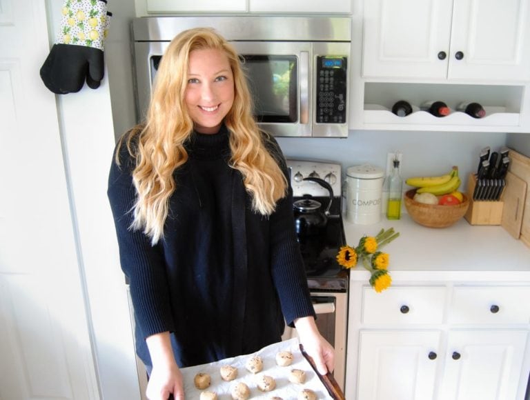 Picture of female home cook in her kitchen holding tray of cookies ready to put in the oven