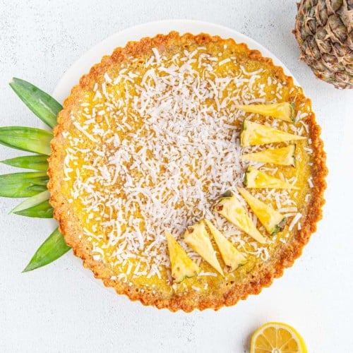 Pineapple Pie with Graham Cracker Crust garnished with coconu flakes and pineapple wedges