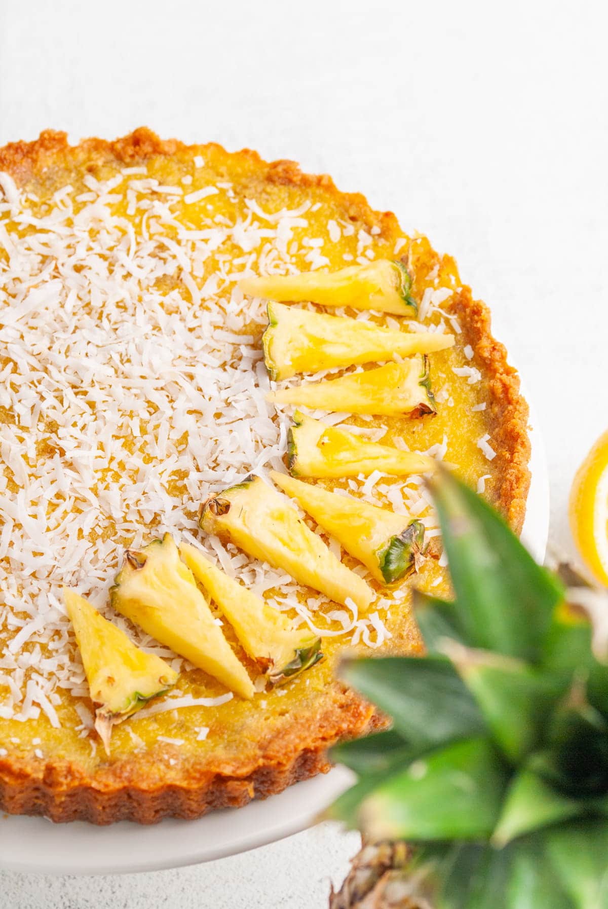 pineapple pie with pineapple leaves in the foreground