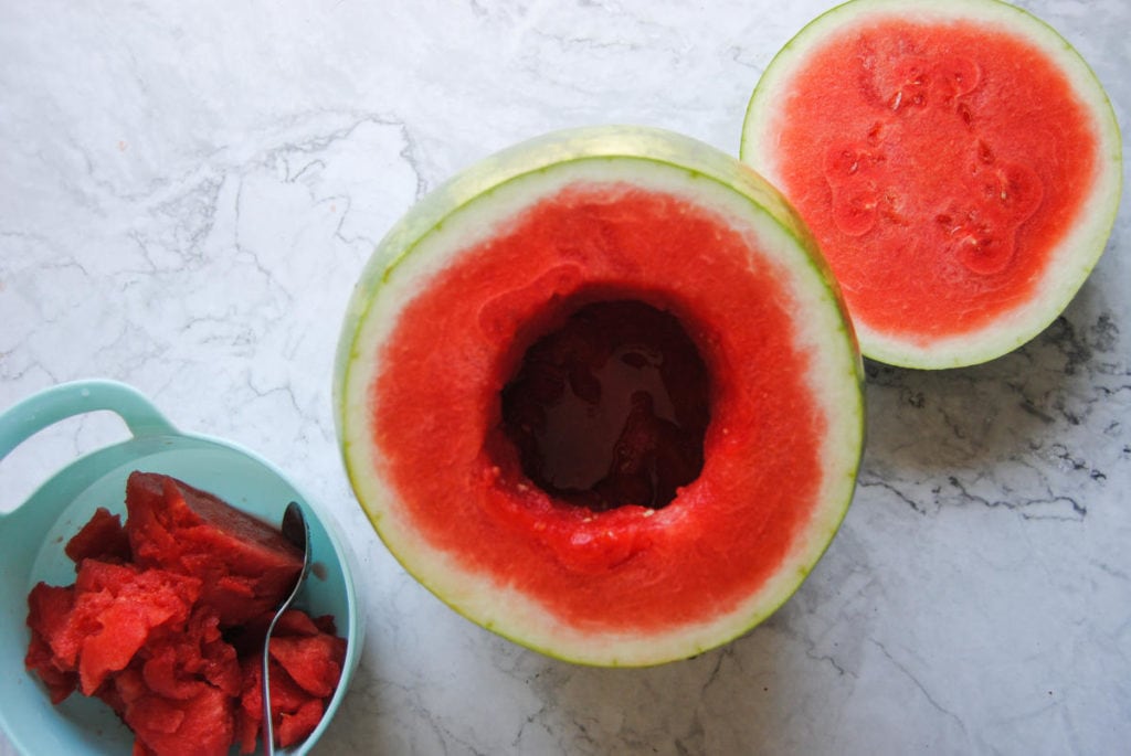 carving a hole in a watermelon to hold sangria