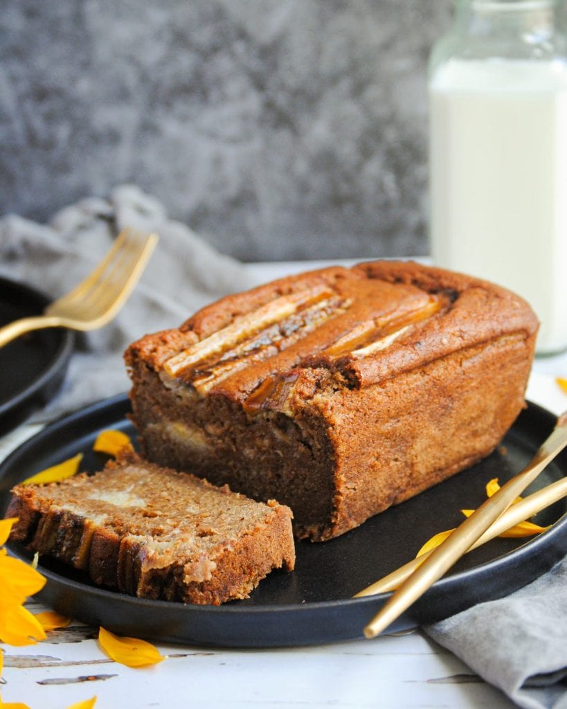portrait of banana bread with one slice cut