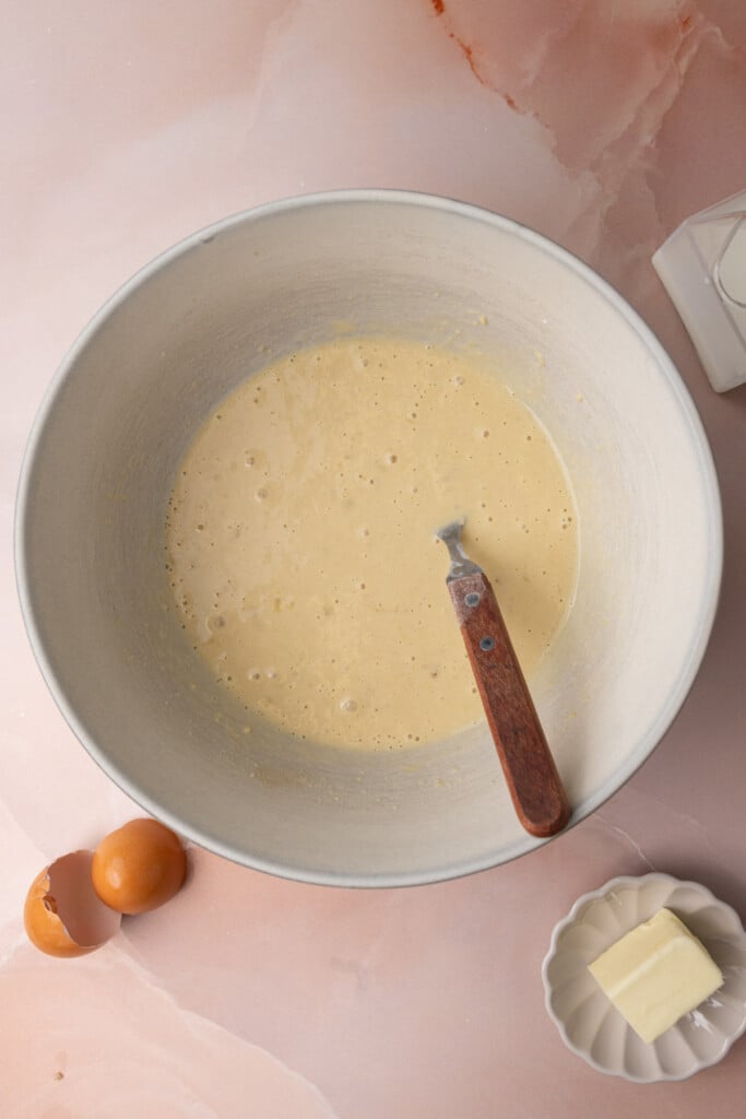 Banana pancake batter in a large micing bowl ready to form pancakes. 