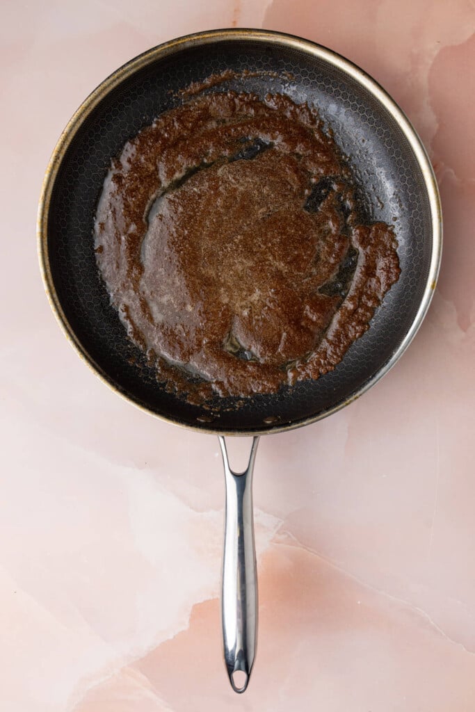 Butter, brown sugar, and cinnamon mixing together in a pan.