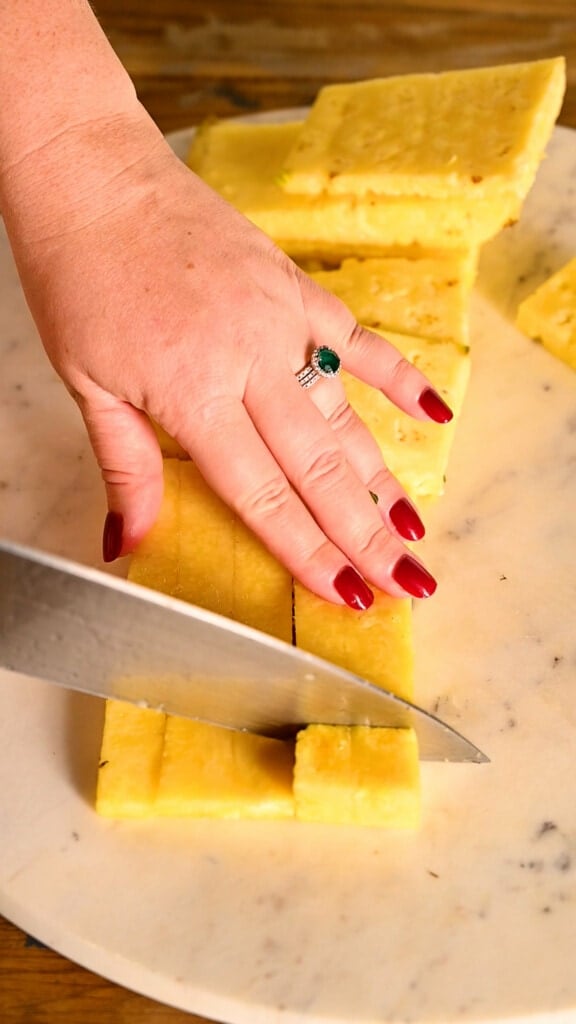 Cutting pineapple into cubes