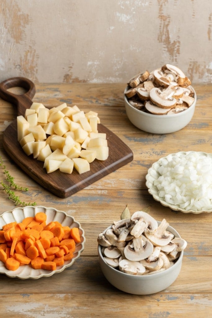 prepped potatoes, mushrooms, onions, and carrot to cook in vegan stew