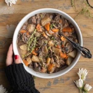 Hearty Mushroom Stew with Potatoes - Cradling bowl with hand