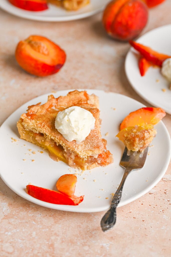 slice of peach mango pie with bite on a fork