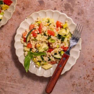 Vegan Couscous Salad with cucumbers, tomatoes, avocado, lemon, and basil
