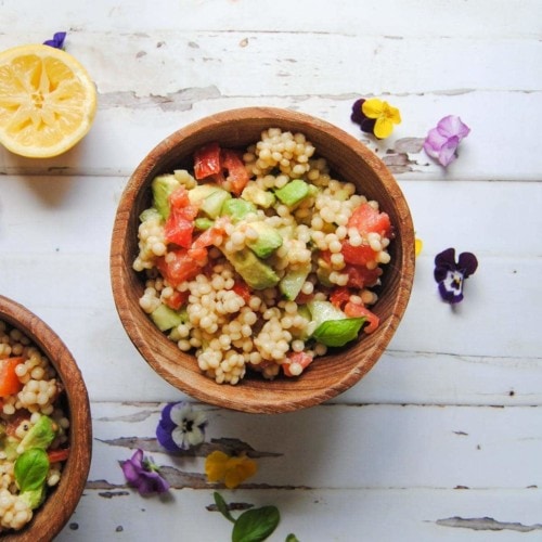 wooden bowl of vegan couscous salad