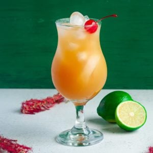 bacardi rum punch in tall glass garnished with cherry