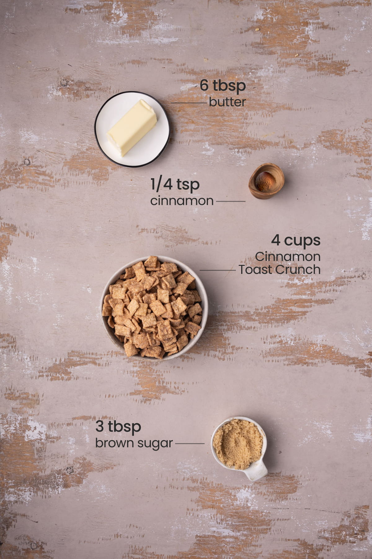 Ingredients for the crust of a cinnamon toast cheesecake layer - butter, cinnamon, cinnamon toast crunch, brown sugar.