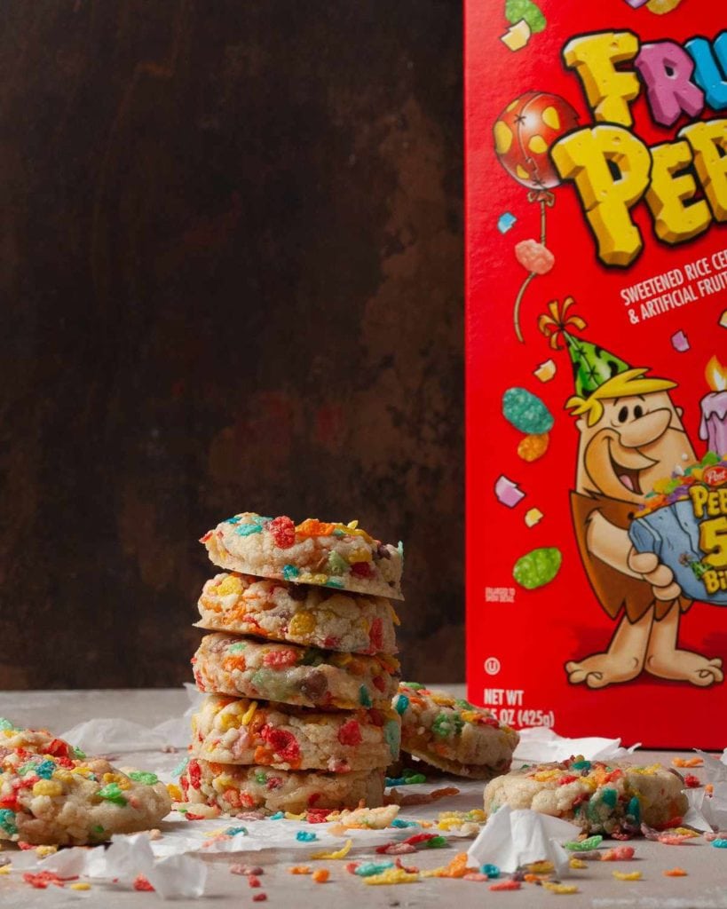 stack of cookies in front of a fruity pebbles box